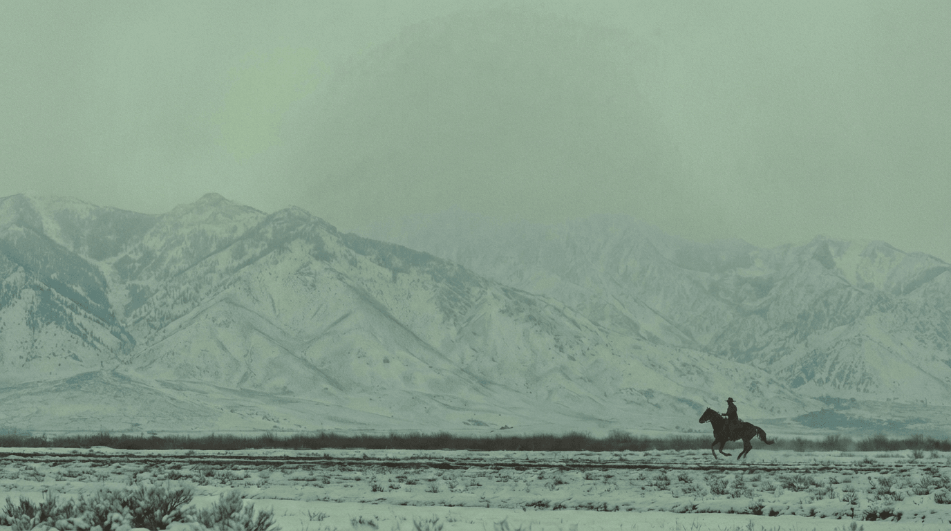 American horseback rider in snowy mountain landscape